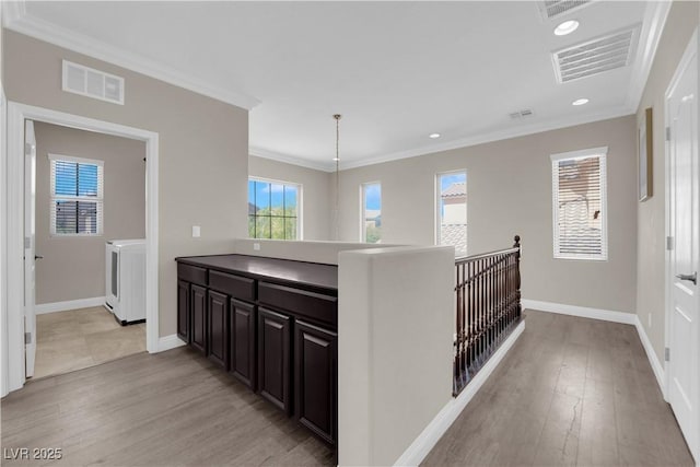 7300 Lavender Rose Ave, Las Vegas, NV 89117 - hallway with light wood-style flooring, washing machine and clothes dryer, crown molding, recessed lighting, and baseboards
