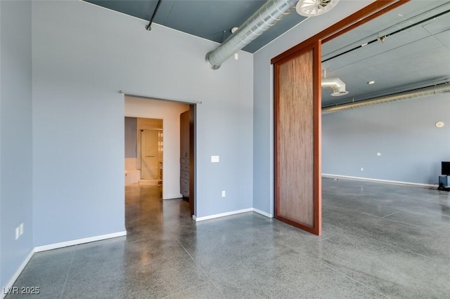 900 Las Vegas Blvd Unit 1209, Las Vegas, NV 89101 - empty room with baseboards, speckled floor, and a towering ceiling