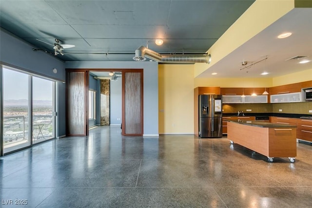 900 Las Vegas Blvd Unit 1209, Las Vegas, NV 89101 - kitchen featuring stainless steel refrigerator with ice dispenser, dark countertops, modern cabinets, a sink, and open floor plan