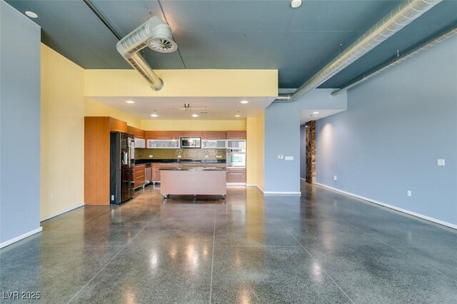 900 Las Vegas Blvd Unit 1209, Las Vegas, NV 89101 - kitchen featuring appliances with stainless steel finishes, dark countertops, light speckled floor, open floor plan, and baseboards