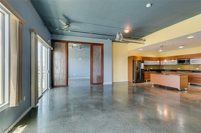 900 Las Vegas Blvd Unit 1209, Las Vegas, NV 89101 - unfurnished living room with light aggregate flooring, healthy amount of natural light, baseboards, and a ceiling fan