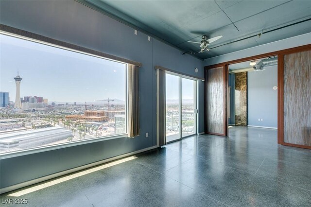 900 Las Vegas Blvd Unit 1209, Las Vegas, NV 89101 - spare room featuring speckle patterned floor, a ceiling fan, and baseboards