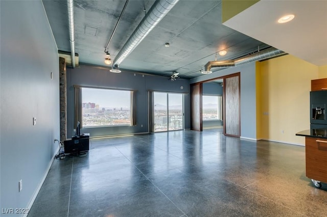 900 Las Vegas Blvd Unit 1209, Las Vegas, NV 89101 - unfurnished room with plenty of natural light, baseboards, and a wood stove