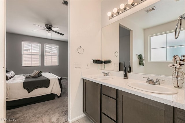 3716 W Colton Ave, North Las Vegas, NV 89032 - full bathroom featuring ensuite bathroom, double vanity, a ceiling fan, and baseboards