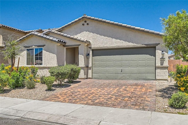 3716 W Colton Ave, North Las Vegas, NV 89032 - mediterranean / spanish-style home with a garage, stucco siding, decorative driveway, and a tile roof