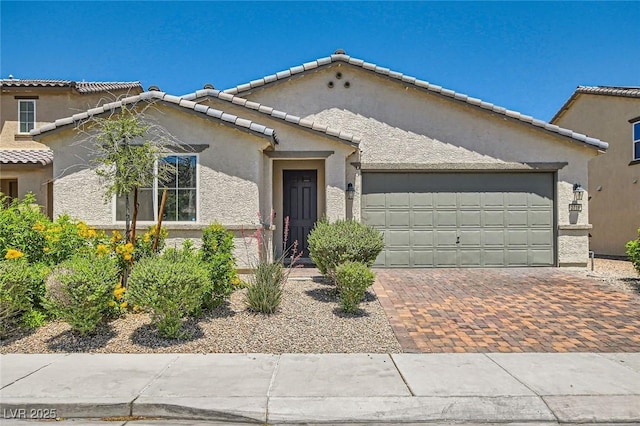 3716 W Colton Ave, North Las Vegas, NV 89032 - mediterranean / spanish house with an attached garage, decorative driveway, and stucco siding