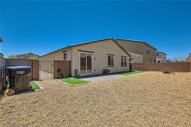 3716 W Colton Ave, North Las Vegas, NV 89032 - back of property with a gate, stucco siding, a fenced backyard, and a patio area