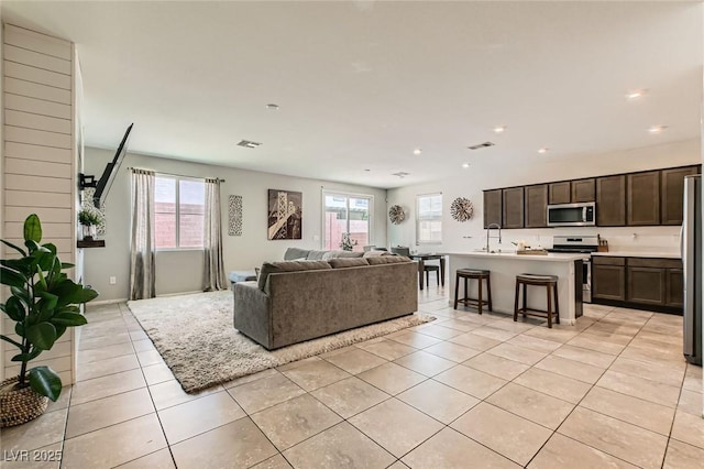 3716 W Colton Ave, North Las Vegas, NV 89032 - living room featuring healthy amount of natural light, recessed lighting, and light tile patterned floors