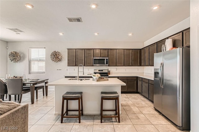 3716 W Colton Ave, North Las Vegas, NV 89032 - kitchen featuring appliances with stainless steel finishes, a sink, dark brown cabinets, light countertops, and light tile patterned flooring