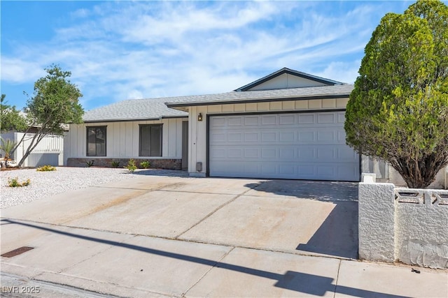 6204 Robin Hood Cir, Las Vegas, NV 89108 - ranch-style house with a shingled roof, driveway, a garage, and board and batten siding