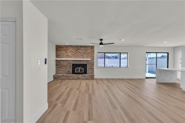 6204 Robin Hood Cir, Las Vegas, NV 89108 - unfurnished living room featuring light wood-type flooring, ceiling fan, baseboards, a fireplace, and recessed lighting