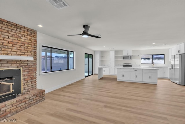 6204 Robin Hood Cir, Las Vegas, NV 89108 - unfurnished living room featuring healthy amount of natural light, light wood finished floors, recessed lighting, baseboards, and ceiling fan