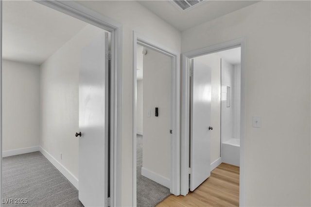 6204 Robin Hood Cir, Las Vegas, NV 89108 - hallway with baseboards and light wood finished floors