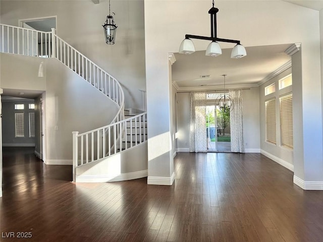 8931 Lansberry Ct, Las Vegas, NV 89147 - entrance foyer featuring stairs, ornamental molding, baseboards, wood finished floors, and a chandelier