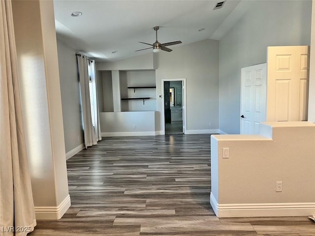 8931 Lansberry Ct, Las Vegas, NV 89147 - unfurnished living room featuring a ceiling fan, lofted ceiling, baseboards, and dark wood-type flooring