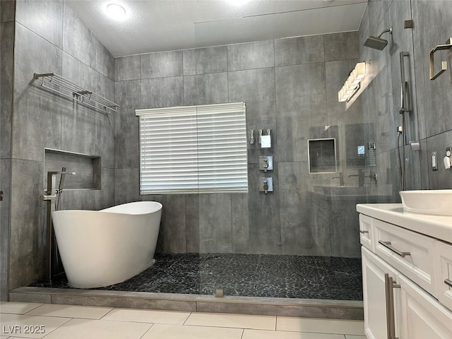 8931 Lansberry Ct, Las Vegas, NV 89147 - full bath featuring tiled shower, vanity, a soaking tub, and tile patterned flooring