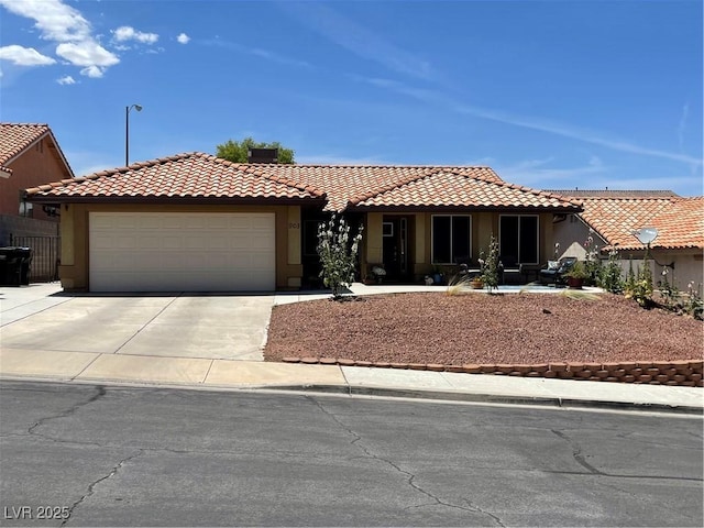 903 Billings St, Henderson, NV 89002 - view of front facade featuring stucco siding, a garage, concrete driveway, and a tiled roof