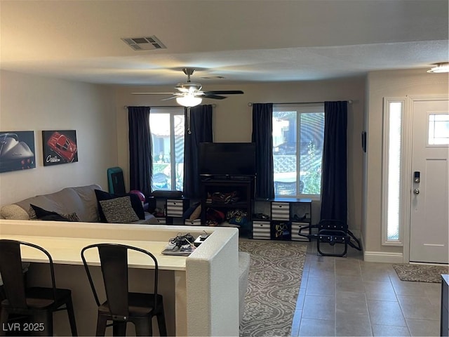 903 Billings St, Henderson, NV 89002 - living area with healthy amount of natural light, tile patterned flooring, a ceiling fan, and baseboards