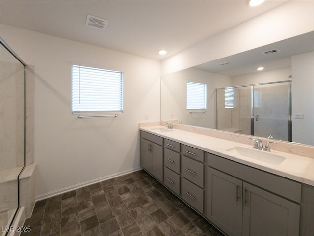 5904 Becklow Gardens Ave, Las Vegas, NV 89141 - bathroom with baseboards, double vanity, a shower stall, and recessed lighting