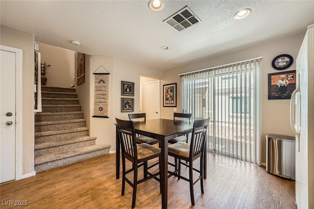 10456 Prairie Schooner Ave, Las Vegas, NV 89129 - dining area featuring wood finished floors, stairway, baseboards, a textured ceiling, and recessed lighting