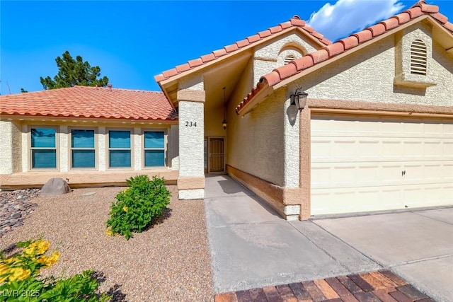 234 Geronimo Ct, Henderson, NV 89074 - view of front of property with an attached garage, a tile roof, and stucco siding