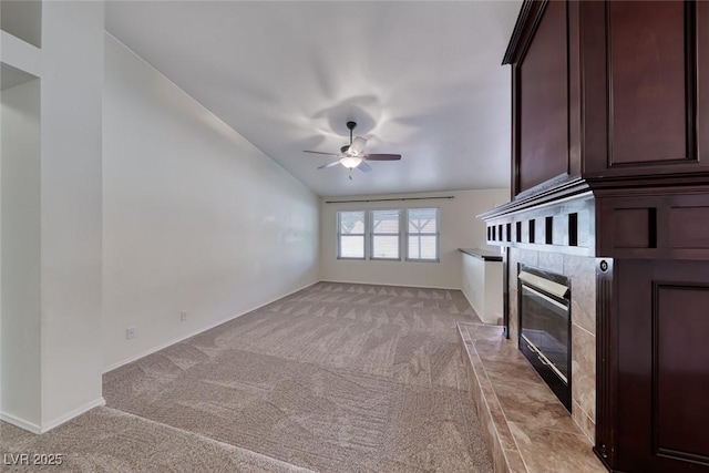 234 Geronimo Ct, Henderson, NV 89074 - unfurnished living room featuring ceiling fan, light carpet, a high end fireplace, and lofted ceiling