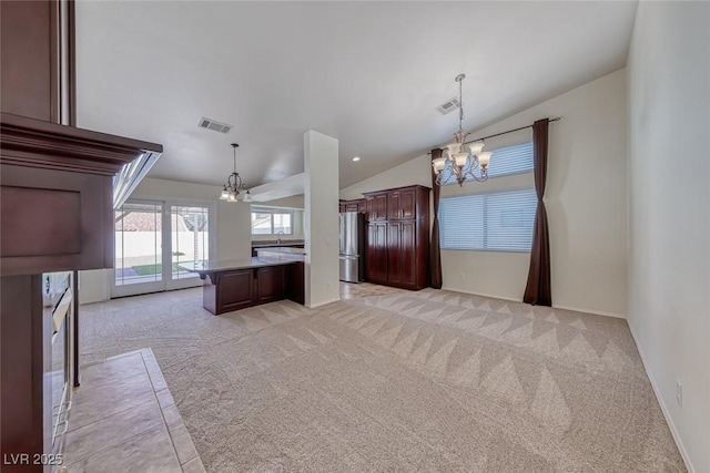 234 Geronimo Ct, Henderson, NV 89074 - kitchen with a chandelier, freestanding refrigerator, vaulted ceiling, light carpet, and a center island