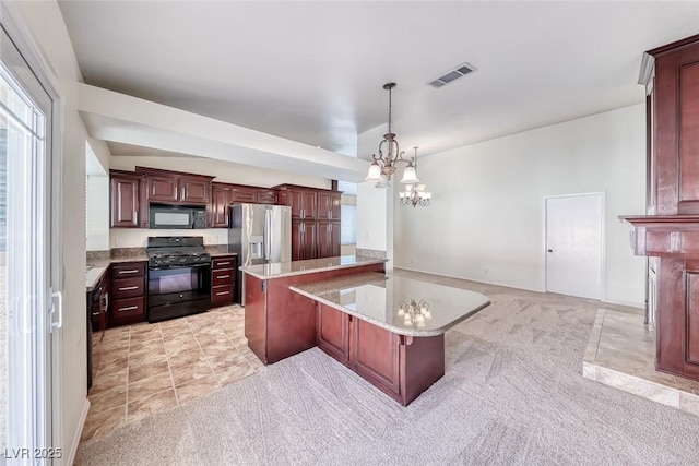 234 Geronimo Ct, Henderson, NV 89074 - kitchen with black appliances, light carpet, a chandelier, decorative light fixtures, and a breakfast bar