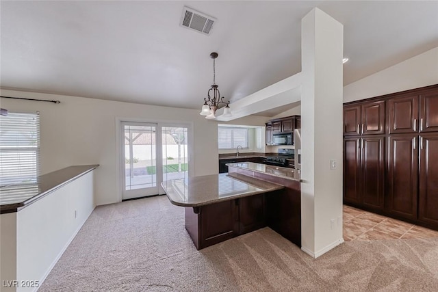 234 Geronimo Ct, Henderson, NV 89074 - kitchen with lofted ceiling, light colored carpet, a peninsula, stove, and dark brown cabinetry