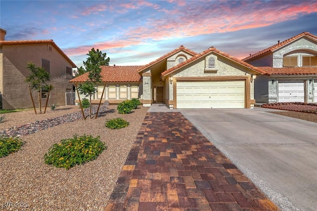 234 Geronimo Ct, Henderson, NV 89074 - view of front of home featuring a tile roof, concrete driveway, stucco siding, and a garage