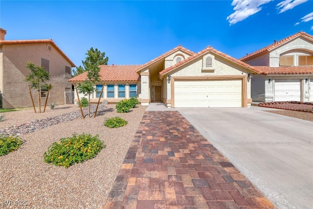 234 Geronimo Ct, Henderson, NV 89074 - view of front of house featuring a tile roof, concrete driveway, stucco siding, and a garage