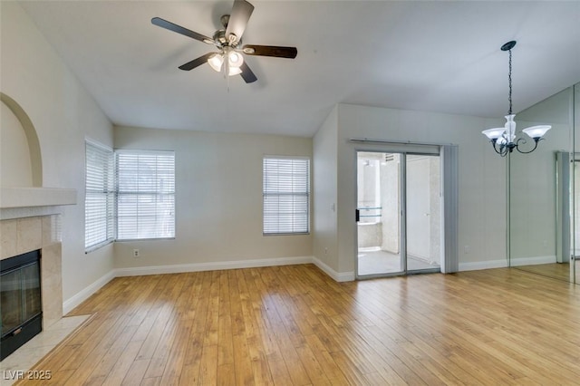 2251 Wigwam Pkwy Unit 824, Henderson, NV 89074 - unfurnished living room featuring a tile fireplace, a ceiling fan, a chandelier, and baseboards