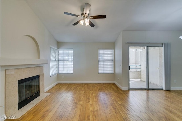 2251 Wigwam Pkwy Unit 824, Henderson, NV 89074 - unfurnished living room featuring ceiling fan, hardwood / wood-style flooring, baseboards, and a tile fireplace