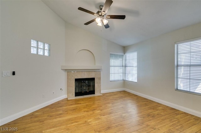 2251 Wigwam Pkwy Unit 824, Henderson, NV 89074 - unfurnished living room featuring vaulted ceiling, light wood-type flooring, a ceiling fan, a tile fireplace, and baseboards