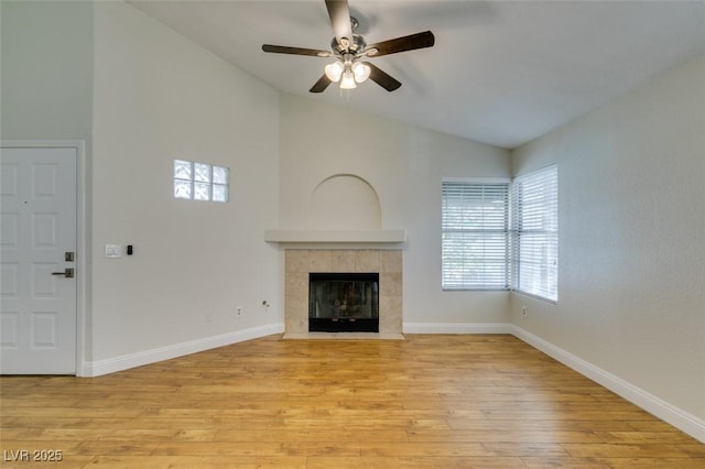 2251 Wigwam Pkwy Unit 824, Henderson, NV 89074 - unfurnished living room with lofted ceiling, light wood-style flooring, ceiling fan, healthy amount of natural light, and a fireplace