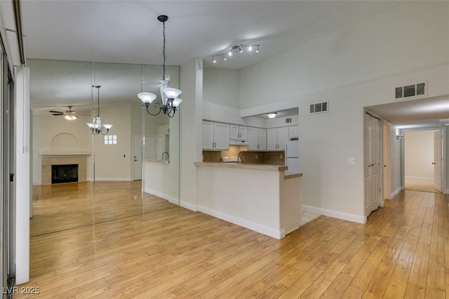 2251 Wigwam Pkwy Unit 824, Henderson, NV 89074 - kitchen featuring freestanding refrigerator, open floor plan, baseboards, a chandelier, and a high ceiling