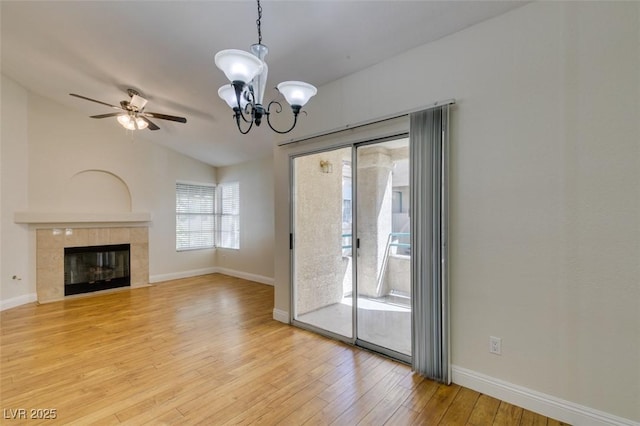2251 Wigwam Pkwy Unit 824, Henderson, NV 89074 - unfurnished living room featuring a chandelier, light wood-style floors, vaulted ceiling, baseboards, and a fireplace