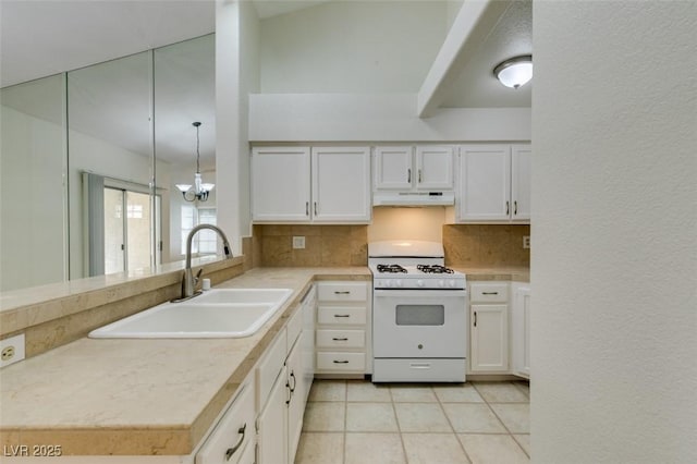 2251 Wigwam Pkwy Unit 824, Henderson, NV 89074 - kitchen with white gas range, under cabinet range hood, a sink, backsplash, and light tile patterned floors