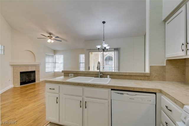 2251 Wigwam Pkwy Unit 824, Henderson, NV 89074 - kitchen with dishwasher, a sink, a fireplace, light wood finished floors, and a ceiling fan