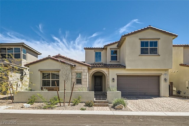 182 Robledo St, Las Vegas, NV 89138 - view of front of home featuring a tile roof, a fenced front yard, an attached garage, driveway, and stucco siding