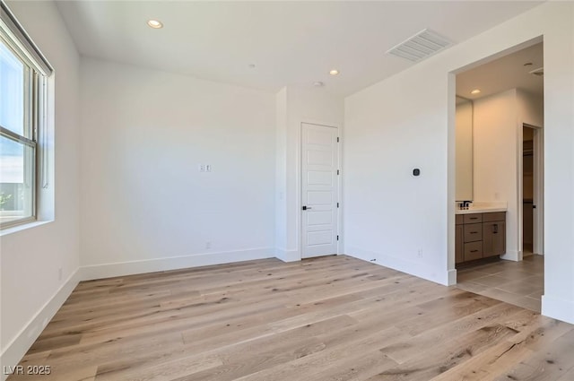 182 Robledo St, Las Vegas, NV 89138 - unfurnished bedroom featuring light wood-style flooring, a sink, recessed lighting, baseboards, and ensuite bathroom