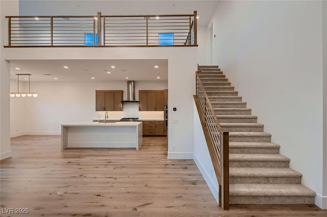 182 Robledo St, Las Vegas, NV 89138 - stairway featuring wood finished floors, baseboards, a high ceiling, and recessed lighting