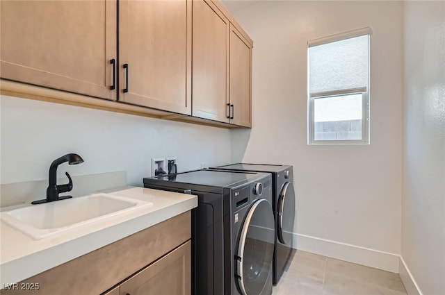 182 Robledo St, Las Vegas, NV 89138 - laundry room with cabinet space, washer and dryer, baseboards, and light tile patterned flooring