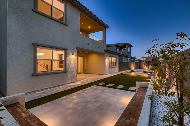 182 Robledo St, Las Vegas, NV 89138 - back of property with a balcony, a patio area, stucco siding, and a fenced backyard