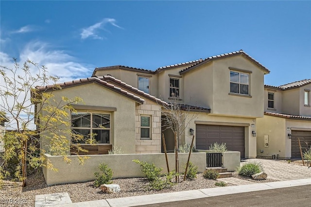 182 Robledo St, Las Vegas, NV 89138 - mediterranean / spanish-style house featuring a fenced front yard, stucco siding, an attached garage, a tiled roof, and driveway