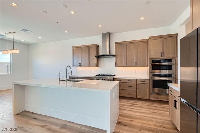 182 Robledo St, Las Vegas, NV 89138 - kitchen with a sink, appliances with stainless steel finishes, wall chimney exhaust hood, light wood finished floors, and recessed lighting