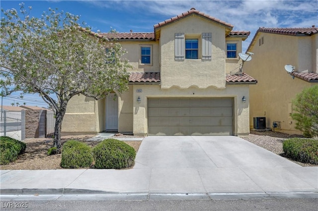 1952 W Hammer Ln, North Las Vegas, NV 89031 - mediterranean / spanish-style home with a tile roof, stucco siding, a garage, concrete driveway, and central AC unit