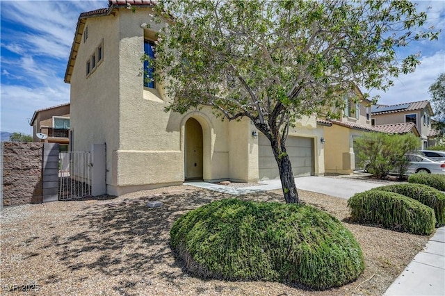 1952 W Hammer Ln, North Las Vegas, NV 89031 - mediterranean / spanish home featuring stucco siding, a gate, a garage, driveway, and a tile roof