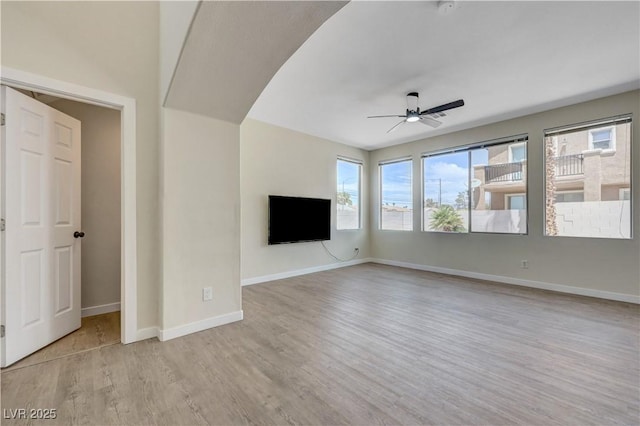 1952 W Hammer Ln, North Las Vegas, NV 89031 - unfurnished living room with a ceiling fan, healthy amount of natural light, light wood-style flooring, and baseboards
