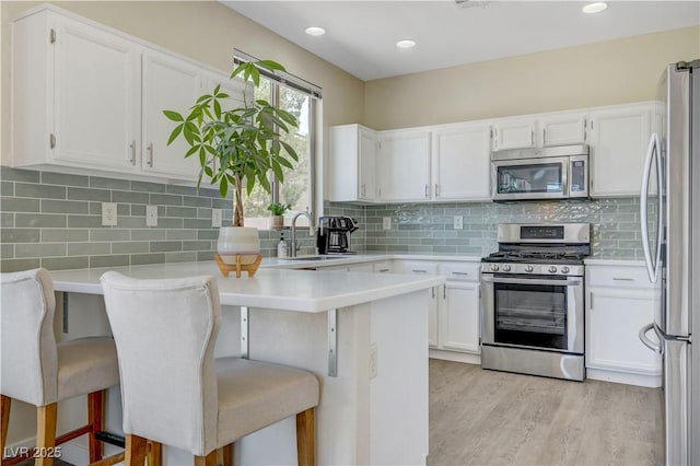 1952 W Hammer Ln, North Las Vegas, NV 89031 - kitchen featuring stainless steel appliances, a sink, light countertops, white cabinetry, and recessed lighting
